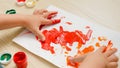 Closeup of colorful drawing picture drawn with child fingers. Little boy painting with colorful gouache paint Royalty Free Stock Photo