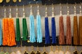 Closeup of colorful earrings with beads on the shelves under the lights