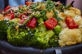 Closeup of colorful grilled vegetables in a cast iron kettle. Royalty Free Stock Photo