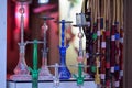 Closeup of colorful hookahs on sale under the lights with a blurry background