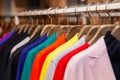 Closeup colorful male, female clothes in boutique hanging on hangers, clothing rack on metal stand. Concept opening Royalty Free Stock Photo