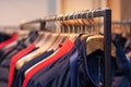 Closeup colorful male, female clothes in boutique hanging on hangers, clothing rack on metal stand. Concept opening Royalty Free Stock Photo