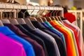 Closeup colorful male, female clothes in boutique hanging on hangers, clothing rack on metal stand. Concept opening