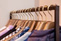 Closeup colorful male, female clothes in boutique hanging on hangers, clothing rack on metal stand. Concept opening Royalty Free Stock Photo