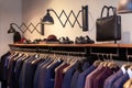 Closeup colorful male, female clothes, shoes in boutique hanging on hangers, clothing rack. Concept opening luxury shop