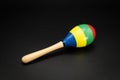 A colorful maracas lying on a black underground Royalty Free Stock Photo