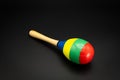 A colorful maracas lying on a black underground Royalty Free Stock Photo