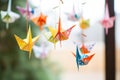 closeup of colorful paper origami birds on string Royalty Free Stock Photo