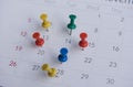 Closeup colorful pins push marking on a calendar. busy schedule Royalty Free Stock Photo