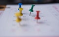 Closeup colorful pins push marking on a calendar. busy schedule Royalty Free Stock Photo