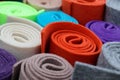 Closeup of colorful rolled felt fabrics placed next to each other