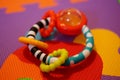 Closeup of a colorful shaking toy on the multi-colored surface Royalty Free Stock Photo