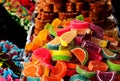 closeup of colorful sugar-coated jelly candy on display. street vendor stand. tasty fruit shapes slices Royalty Free Stock Photo