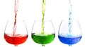 Closeup of colorful water pouring into the glasses Royalty Free Stock Photo