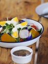 Closeup of colourful fresh organic healthy lettuce leaf vegetables and cabbage served with hen egg in  white metal bowl and home Royalty Free Stock Photo