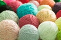 Closeup colourful yarn balls lying in a pile