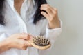 Closeup of comb brush with long loss hair .Woman loosing hair for head healthcare problem with copy space. Royalty Free Stock Photo