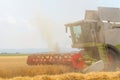Closeup Combine harvesting a wheat field. Combine working the fi