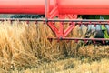 Closeup Combine harvesting a wheat field. Combine working the field Royalty Free Stock Photo