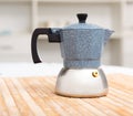 Closeup of moka pot standing on wooden table