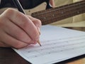 Closeup of composer child girl hand writing notes in notebook Royalty Free Stock Photo