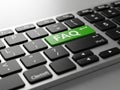 Closeup of a computer keyboard with a green faq button on a gray surface Royalty Free Stock Photo