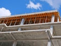 Closeup of concrete frame structure showing formwork for concrete slab. New multi-story apartment