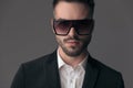 Closeup of confident fashion model wearing suit and sunglasses Royalty Free Stock Photo