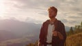 Closeup confident man hiking mountains. Relaxed tourist travel on summer holiday