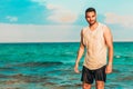 Healthy young man with a turquoise sea as a background Royalty Free Stock Photo