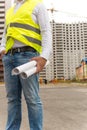 Closeup of construction engineer standing at building site and h Royalty Free Stock Photo