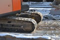 Closeup Continuous tracks or Tracked wheel of excavator or backhoe on the soil floor