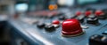 Closeup of a control panel with a prominent red button, showcasing industrial technology and emergency stop functionality in a Royalty Free Stock Photo
