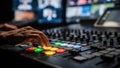 Closeup of a control room master switcher manipulating the vision mixer sharp focus on hands and buttons with blurred Royalty Free Stock Photo