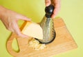 Closeup of cook grating cheese