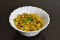 Closeup of cooked corn in a white bowl.