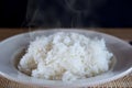 Cooked hot rice in white plate with smoke Royalty Free Stock Photo