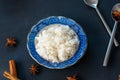 Closeup cooked steam jasmine rice in a blue plat on black background