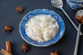 Closeup cooked steam jasmine rice in a blue plat on black background