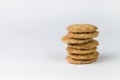 Closeup cookies are arranged in multiple pieces, stacked together, and the cookies are brown and the image has blank space beside