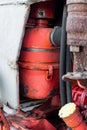 Closeup of coolant reservoir in old vibrant red rusty russian tractor engine on sunny autumn day sharp detail of agriculture