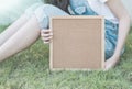 Closeup cork board in hand of woman beside the body