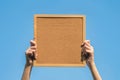 Closeup cork board in hand of woman with sun light Royalty Free Stock Photo