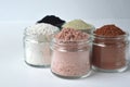 A closeup of cosmetic clays for detox face masks - French green clay, kaolin, pink clay, red clay and powdered activated charcoal Royalty Free Stock Photo