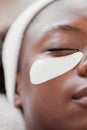 Closeup, cosmetics and black woman, eye patch and skincare for beauty, wellness and luxury treatment. Zoom, Nigerian