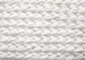 Closeup cotton white knit blanket, warm and comfortable atmosphere. Knit background.