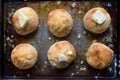 Closeup of Country Biscuits with butter in rustic setting