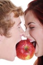 Closeup of couple biting apple. Royalty Free Stock Photo