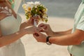 Closeup of a couple exchanging wedding rings during a wedding ceremony on the beach Royalty Free Stock Photo