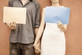 Closeup couple holding hands and holding frames at wall background Royalty Free Stock Photo